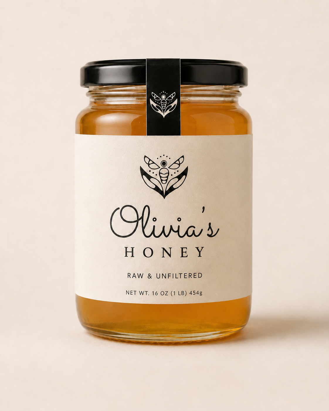 Jar of Olivia's Honey with a black lid on a beige background