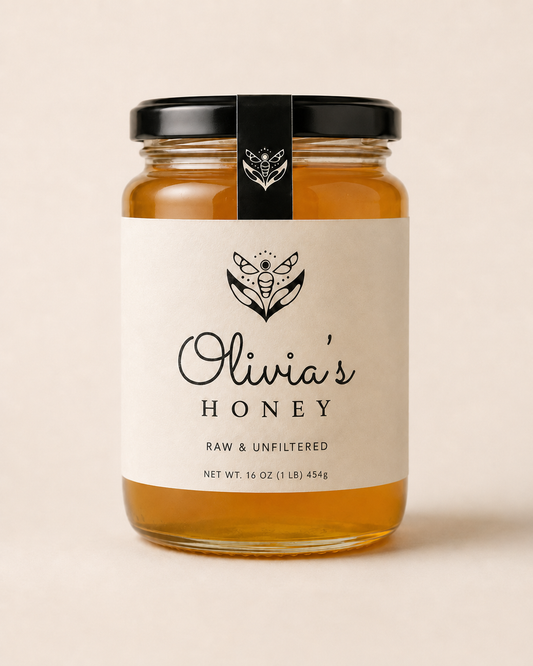 Jar of Olivia's Honey with a black lid on a beige background
