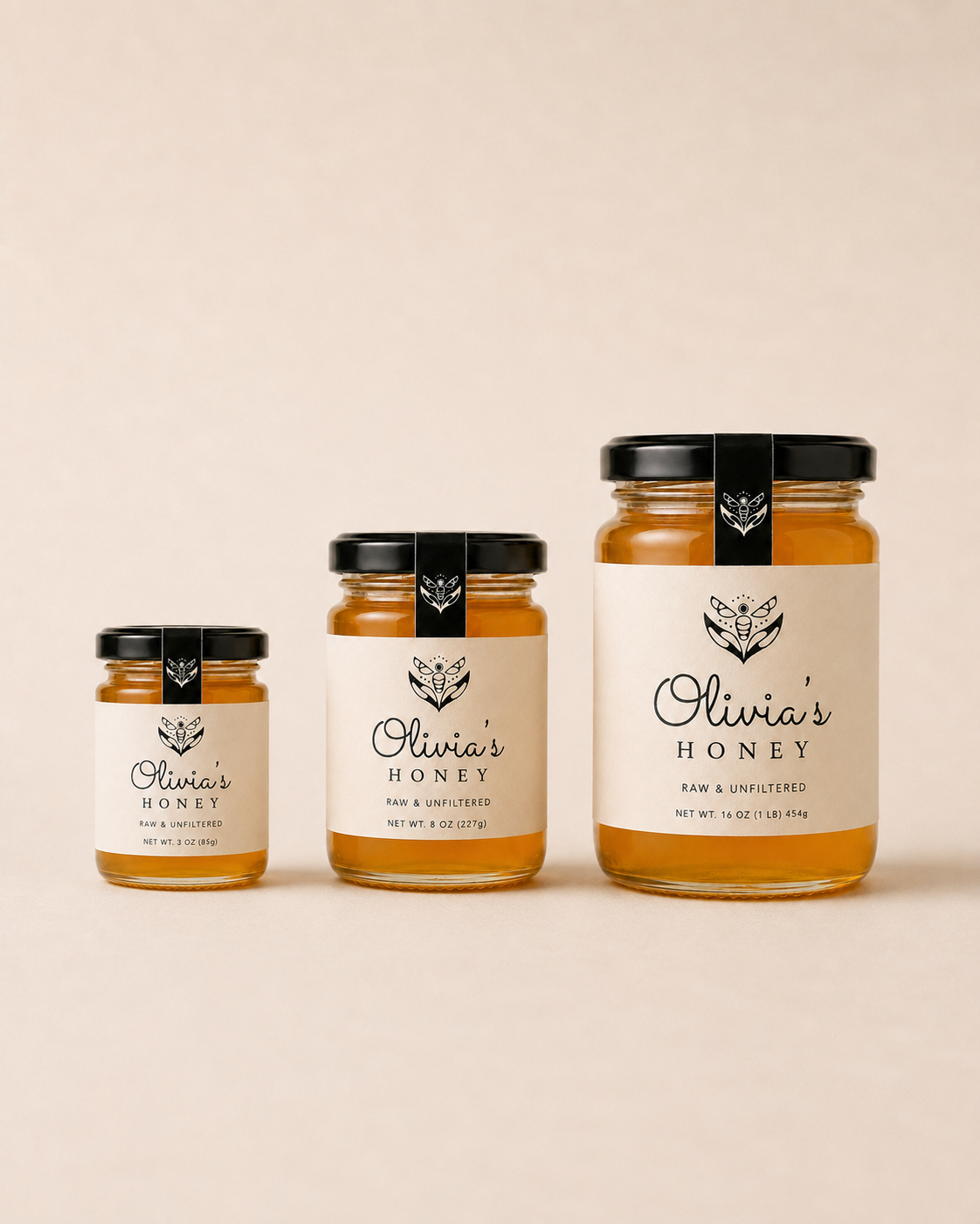 Three jars of Olivia's Honey on a beige background