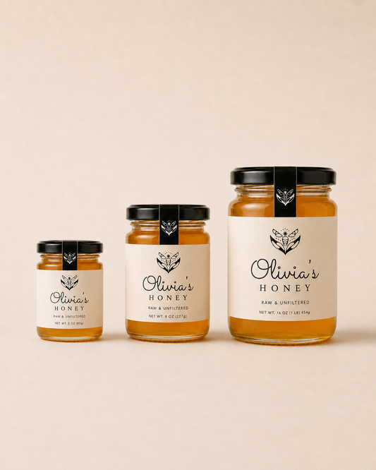 Three jars of Olivia's Honey on a beige background